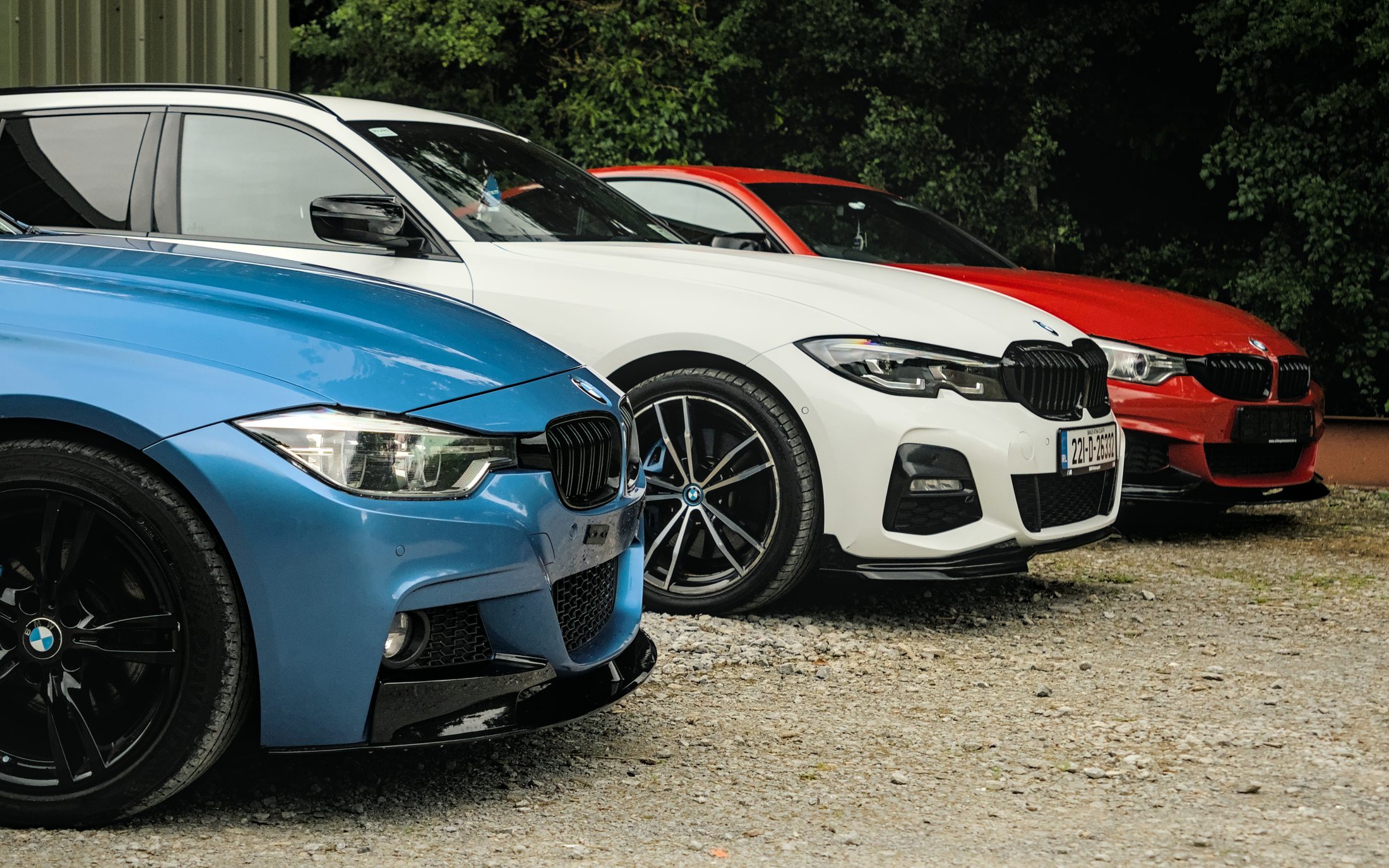 Blue, white and red BMWs lined up outside the Body Styling Ireland workshop
