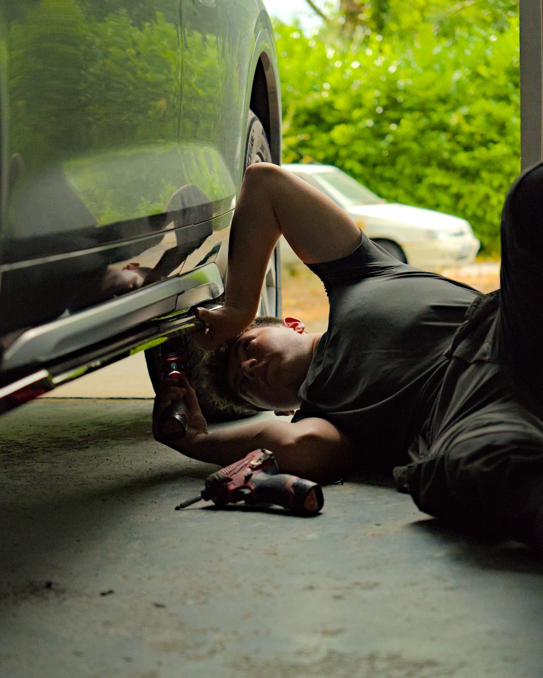 BSI fitter working under a car, fitting side skirts