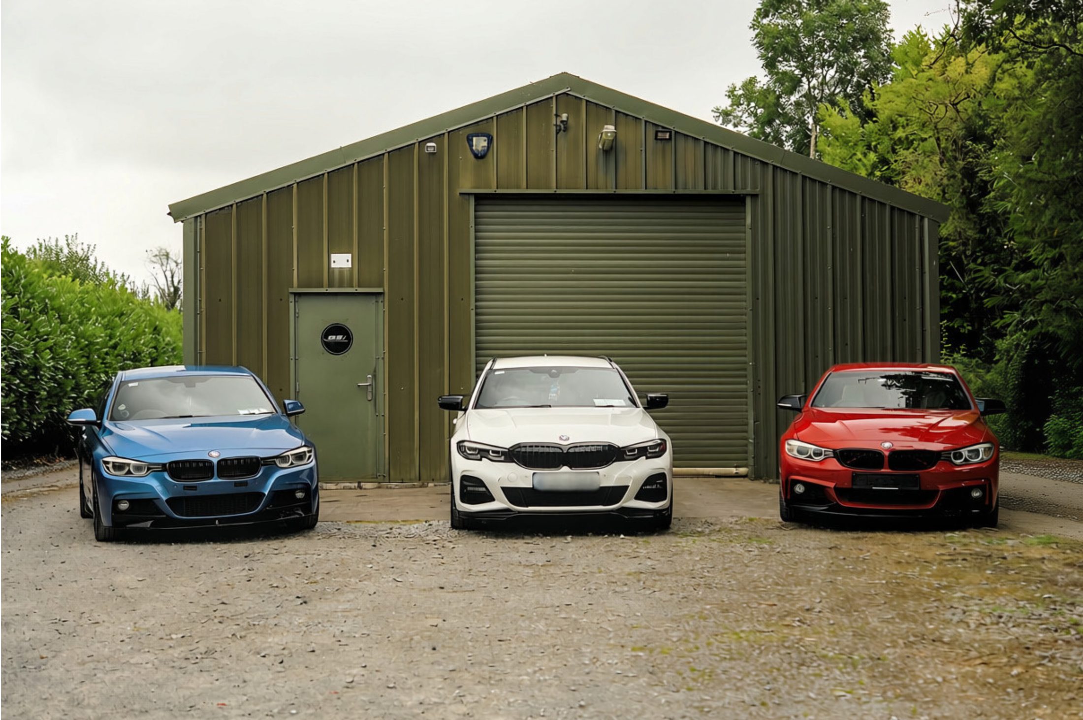 Three styled BMWs parked outside the Craughwell workshop