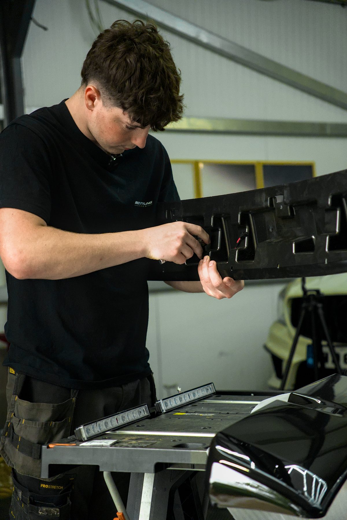 Fitting LED units into a bumper at the Body Styling Ireland workshop